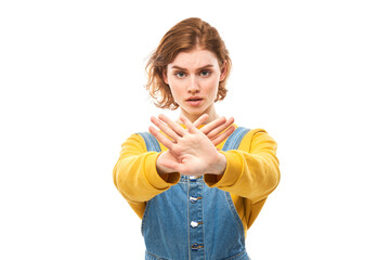 Portrait of young redhead woman showing stop sign with hand isolated on white background