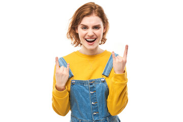 Portrait of young redhead woman showing rock and roll gesture with fingers isolated on white...