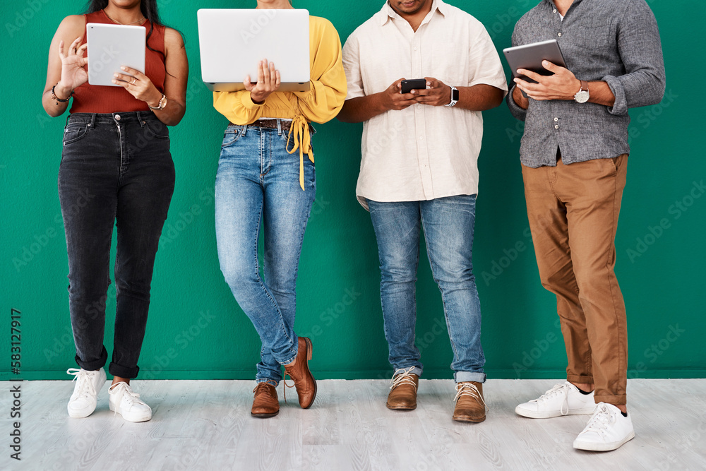 Aufkleber There are many ways to stay connected. Closeup shot of a group of unrecognisable designers using digital devices while standing together against a green background.