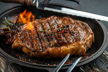 beef grill steak with fire. The concept of cooking meat, Food recipe background. Close up