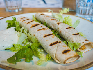 mini mexican tacos, tortilla, wrap burrito and green salad. Fast food, tasty dinner.