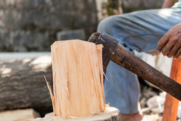 old man chopping wood with an ax