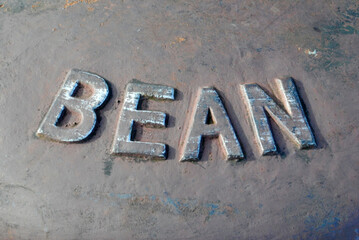 Cast Iron Metal Sign 'Bean' on Vintage Industrial Mooring Bollard  