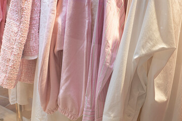 Women's pink shirt on a hanger.