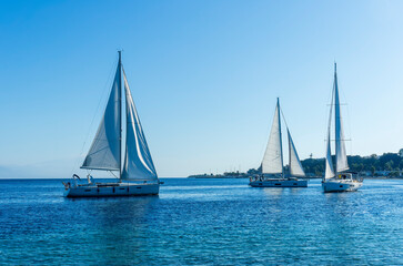 Fototapeta na wymiar boats and yachts at the sailing regatta on open water. Sailing on the wind waves in the sea.