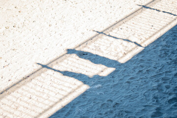 Obraz na płótnie Canvas Shade from the handrails on the sand of the beach