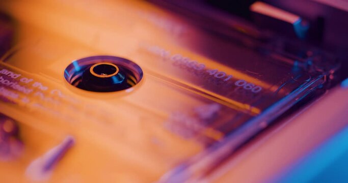 Close up of an old audio cassette tape spinning and playing in old recorder