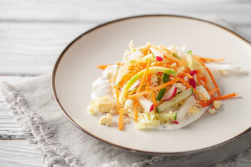 Vegetable mix salad with eggs and sauce in a plate on the table