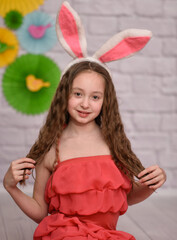 Obraz na płótnie Canvas a girl with rabbit ears. easter vertical photo.