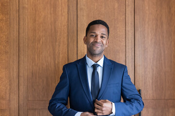 Portrait of African American businessman doing up his suit