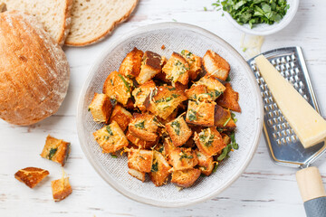 Croutons with herbs, garlic and cheese from white bread or baguette. Served for salad or soup. Selective focus, top view - 583146301