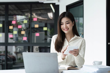 Business woman using calculator for do math finance on wooden desk in office and business working background, tax, accounting, statistics and analytic research concept.