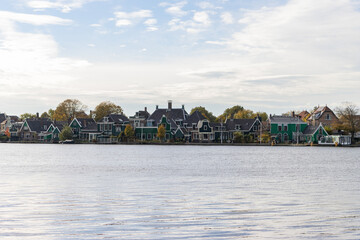 Naklejka premium Traditional Green Buildings along the Zaan River in Zaandijk Netherlands