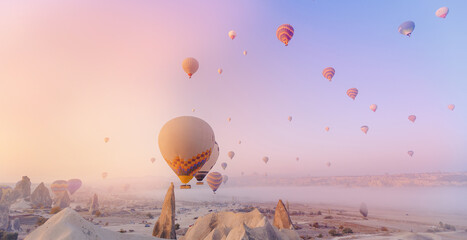 Landscape sunrise in Cappadocia with set colorful hot air balloon fly in sky with sun light....