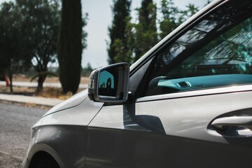 Fototapeta na wymiar Closeup shot of the side of a metallic dark gray car exterior