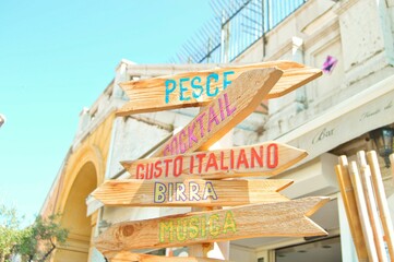 Closeup of wooden signs with words showing directions