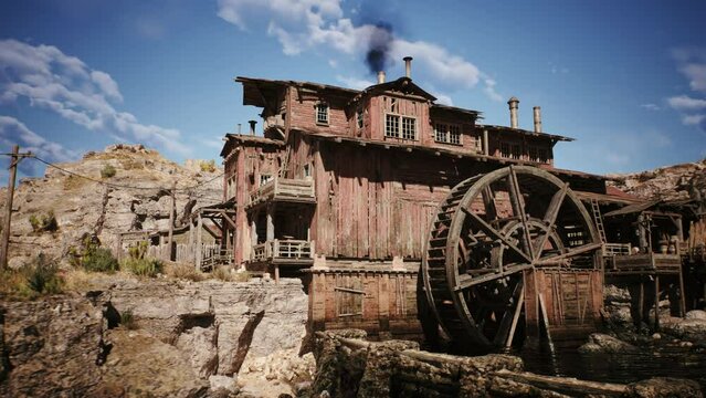 Camera is panning next to an old western lumber mill building in a west town village