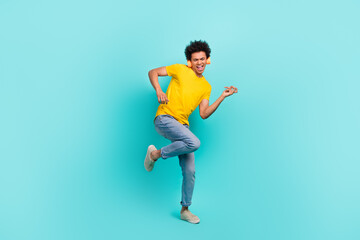 Full size photo of overjoyed careless young man have fun listen music play imagine guitar isolated on teal color background