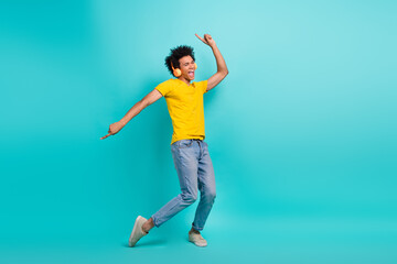 Full size photo of overjoyed cheerful person point fingers dancing listen music isolated on turquoise color background