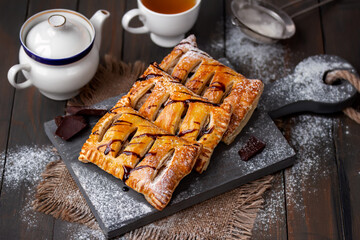 Homemade sweet puff pastries. Baked Puff pastry turnovers with chocolate and fruit filling served...