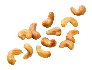 Roasted cashews flying on a white background. Isolated