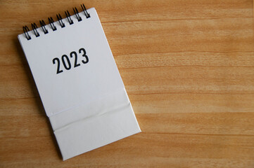 Year 2023 text on white table calendar with customizable space for text or ideas. Copy space and calendar concept.