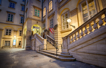 Stairs in the inner yard of Horburg palace in Vienna during evening with street lights