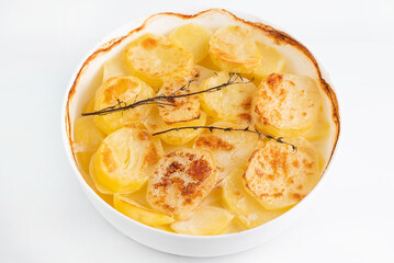 Baked potatoes with thyme sprigs. The concept of cooking homemade food.