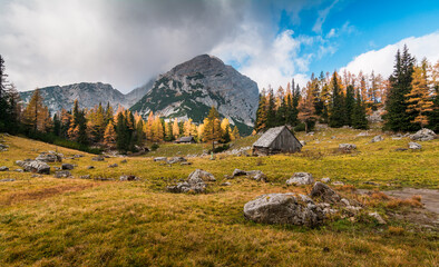 Panorama of mountains in the Gesäuse region in Austria during a sunny day with small huts