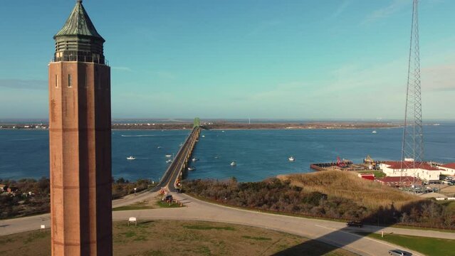 Raising drone over Robert Moses Tower on the green park wit cars by the sea in Fire Island, New York