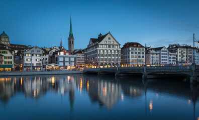Panorama of Zürich city center with historical buildings and church at water with bridge during...