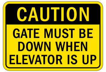 Elevator warning sign and labels gate must be down when elevator is up