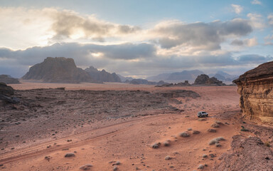 Fototapeta na wymiar Red orange Mars like landscape in Jordan Wadi Rum desert, mountains background, overcast morning. This location was used as set for many science fiction movies