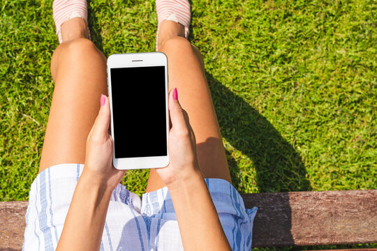 Stylish Teenager Holding Mobile Phone With Empty Screen