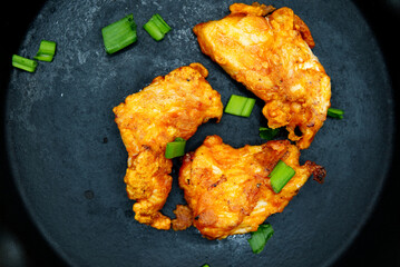 fried chicken nuggets on black cast iron frying pan