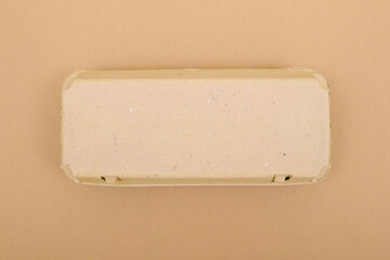 Closed egg box with ten eggs. Close carton pack or egg container top view with copy space. Egg box with chicken eggs, carton pack or egg container.