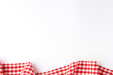 Gingham cloth on white background with copyspace. Top view
