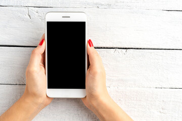 Woman’s hands using smart phone with empty screen