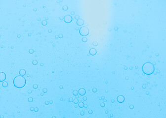 Fototapeta na wymiar Air bubbles in the water background.Abstract oxygen bubbles in the sea.Water bubbles isolate on blue background.Air bubble floating up to top of water surface which little and big circle shape.