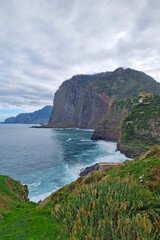 The green slopes of the island of Madeira in the ocean. Evergreen Island. Beautiful nature. A popular island for tourists.