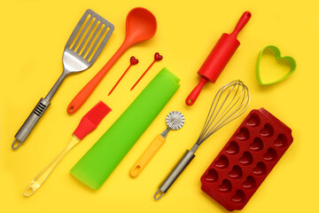 culinary silicone supplies arranged diagonally on a yellow background, culinary background