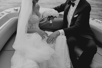 bride and groom newlyweds drinking champagne wine on boat on wedding day sunset romantic boho 