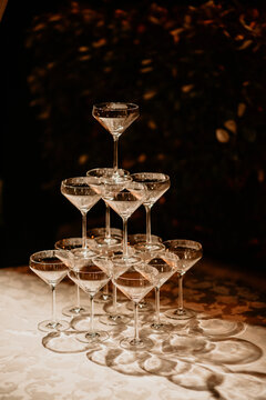 Champagne tower for newlyweds on their wedding day cutting cake drinking wine 