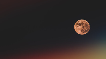 Fantastic view of the moon on black and colorful background, bokeh colors and leaks. Full moon on black background
