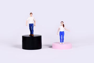 Gender gap concept with man and woman figure on different colored platforms of different highs