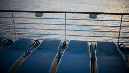 Obraz premium Lounge chairs on a ship out at sea. 