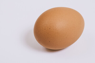 Brown egg close-up on bright background. Macro shot. Selective focus.