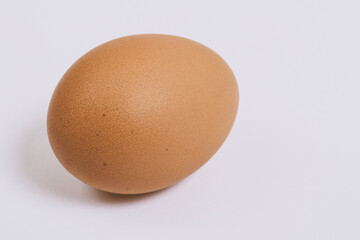 Brown egg close-up on bright background. Macro shot. Selective focus.