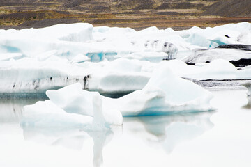 Fototapeta na wymiar Glacier edge and water with reflections