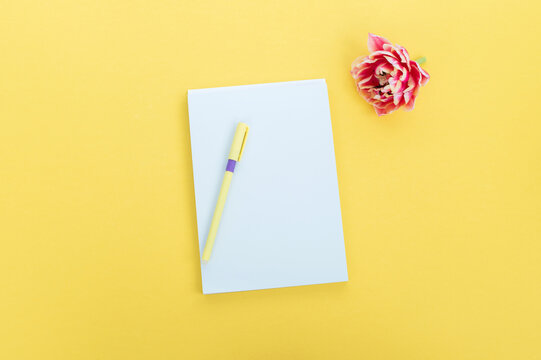 Creative flat photography desktop. Top view yellow desk with blank notebooks mockup with pencil